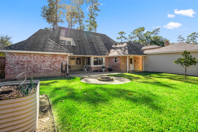 rear view of house featuring a yard and a patio