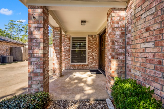 doorway to property with a patio and central AC unit