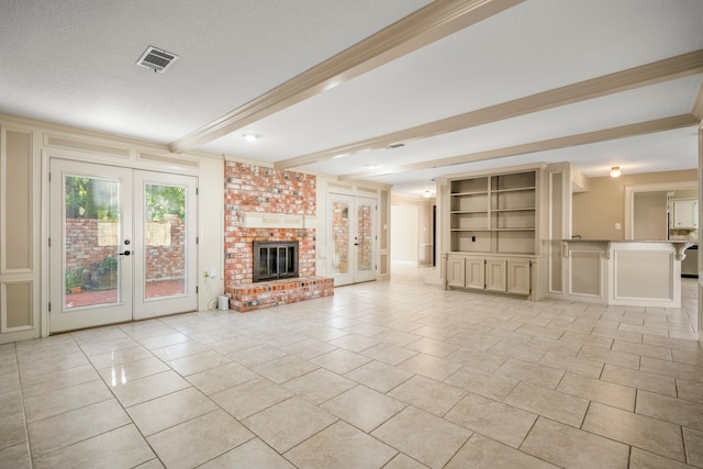 unfurnished living room with french doors, a textured ceiling, light tile patterned floors, beam ceiling, and a fireplace