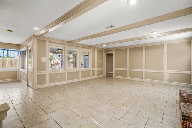 tiled spare room with a textured ceiling