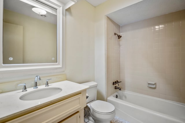 full bathroom with a textured ceiling, vanity, toilet, and tiled shower / bath