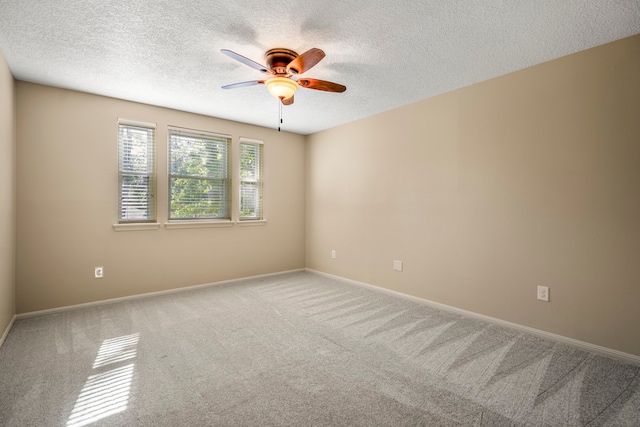 unfurnished room with carpet flooring, ceiling fan, and a textured ceiling