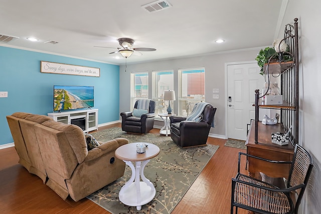 living room with wood-type flooring, ceiling fan, and ornamental molding