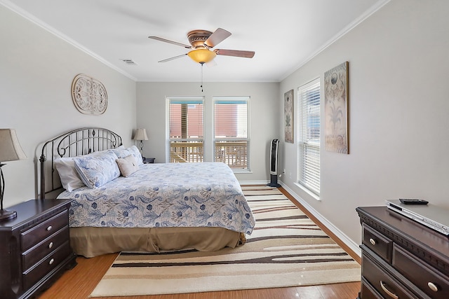 bedroom with ceiling fan, light hardwood / wood-style floors, and ornamental molding