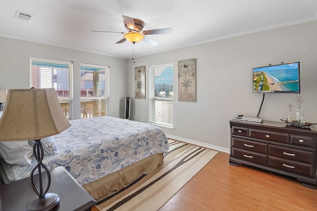 bedroom with ceiling fan, light hardwood / wood-style flooring, and crown molding