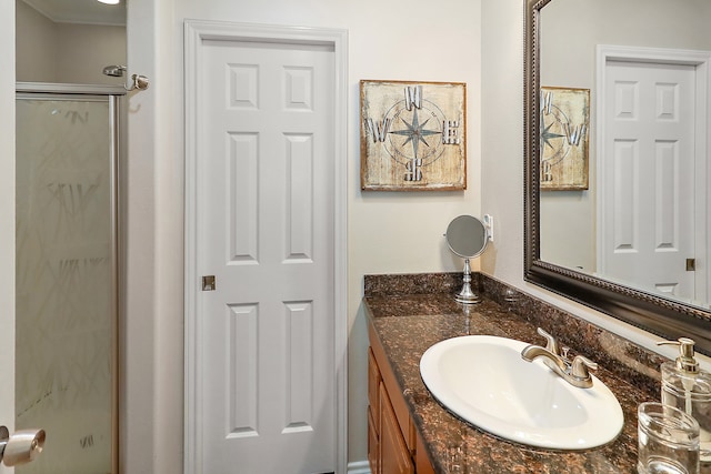 bathroom featuring vanity and an enclosed shower