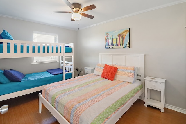 bedroom featuring crown molding, ceiling fan, and dark wood-type flooring