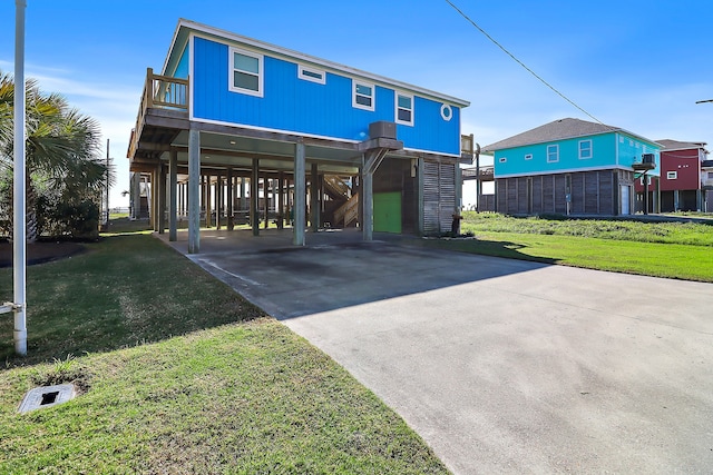 back of property featuring a carport and a lawn