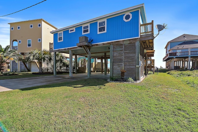 back of property featuring a lawn and a carport