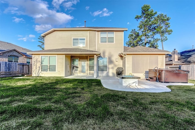 back of house with a patio area, a yard, and a hot tub