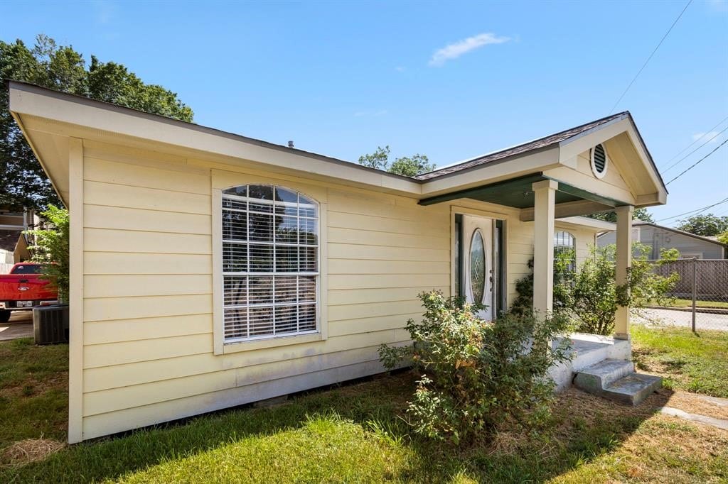 view of side of home with central air condition unit