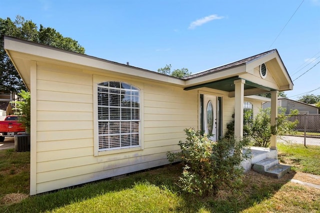 view of side of home with central air condition unit