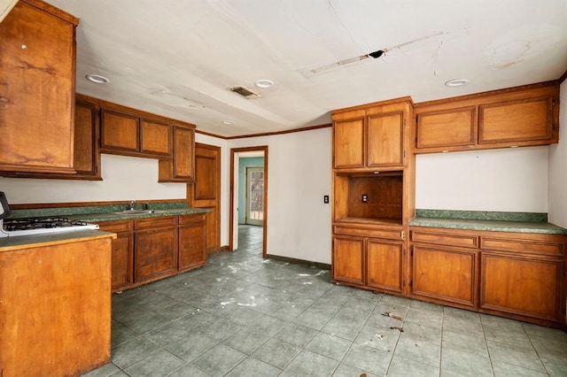 kitchen featuring crown molding, sink, light tile patterned flooring, and white range