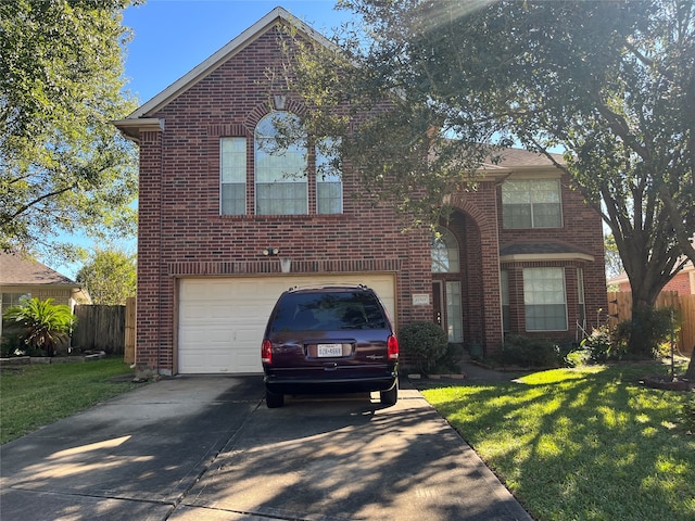 view of property featuring a front yard and a garage