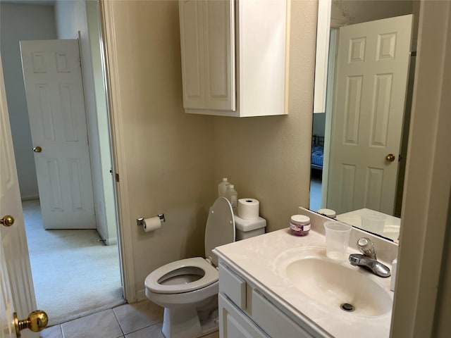 bathroom with tile patterned floors, vanity, and toilet