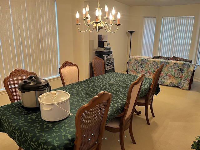 dining area featuring a chandelier and carpet