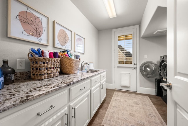 clothes washing area featuring sink and dark wood-type flooring