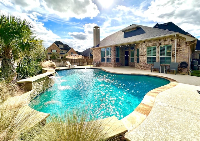 view of pool featuring pool water feature and a patio