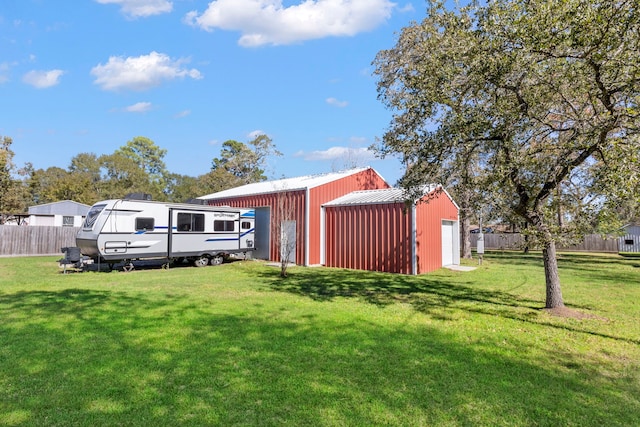 view of yard with a garage and an outdoor structure