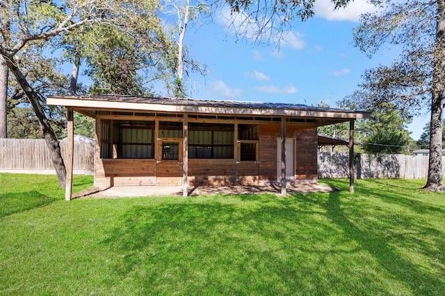 rear view of property with a yard