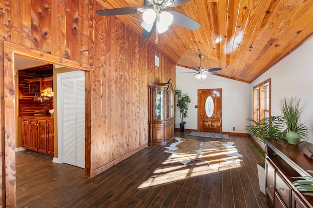 foyer featuring ceiling fan, high vaulted ceiling, wooden ceiling, dark hardwood / wood-style floors, and wood walls