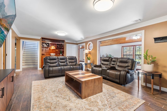 living room with dark hardwood / wood-style flooring and crown molding