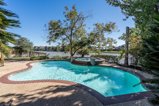 view of pool featuring an in ground hot tub and a water view