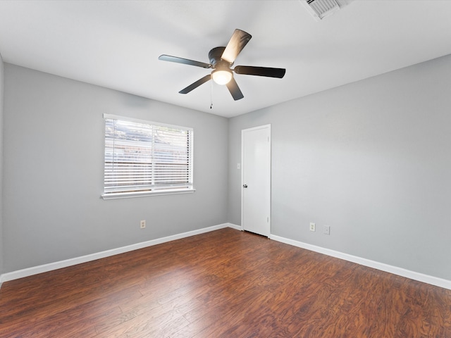 unfurnished room with dark hardwood / wood-style floors and ceiling fan