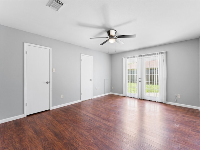 unfurnished room with ceiling fan, dark wood-type flooring, and french doors