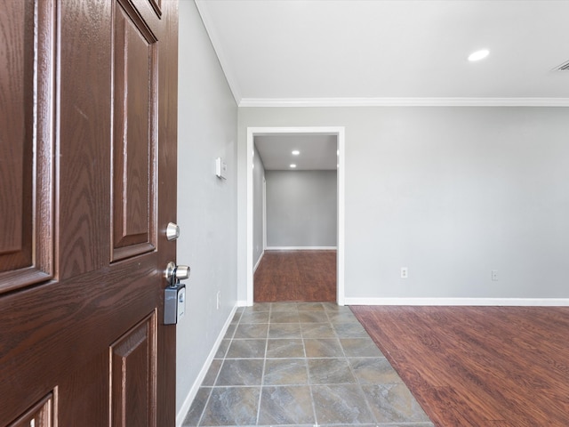 foyer featuring hardwood / wood-style floors and crown molding