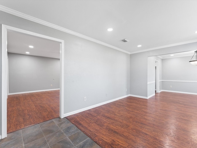 spare room with dark hardwood / wood-style floors and crown molding