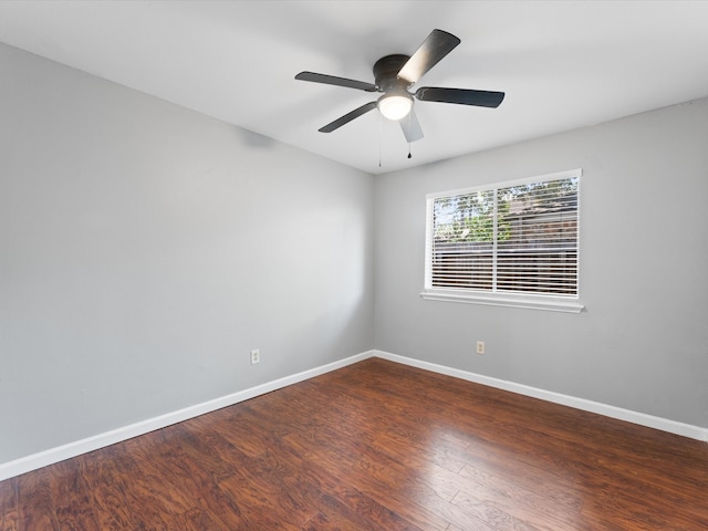 empty room with ceiling fan and dark hardwood / wood-style flooring