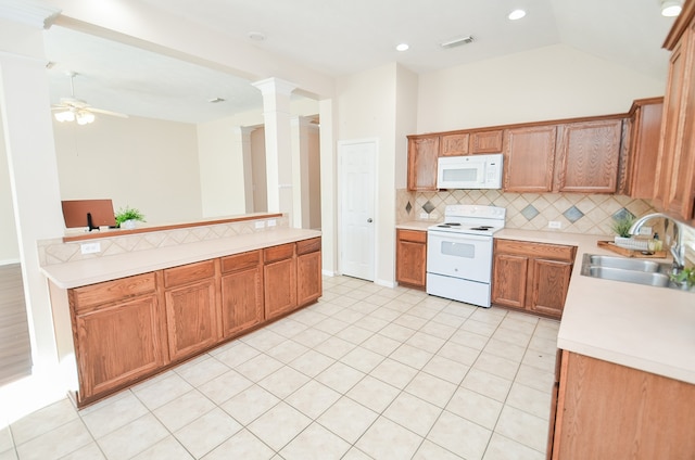 kitchen featuring ceiling fan, sink, backsplash, decorative columns, and white appliances