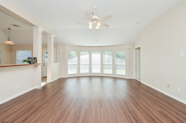 unfurnished living room featuring ornate columns, ceiling fan, wood-type flooring, and vaulted ceiling