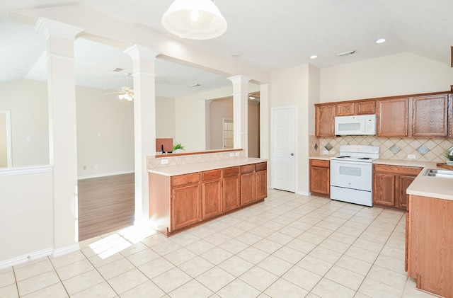 kitchen with white appliances, vaulted ceiling, ceiling fan, tasteful backsplash, and kitchen peninsula