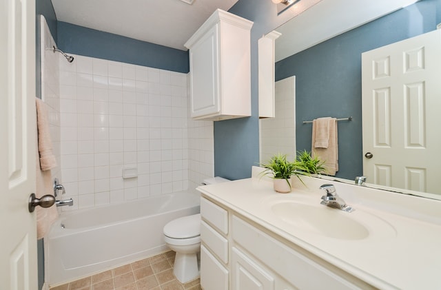 full bathroom featuring vanity, tiled shower / bath combo, and toilet