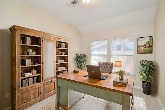 carpeted office space featuring vaulted ceiling