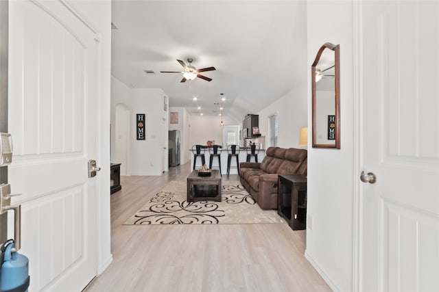 living room featuring ceiling fan and light hardwood / wood-style floors