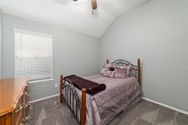 bedroom featuring dark colored carpet, vaulted ceiling, and ceiling fan