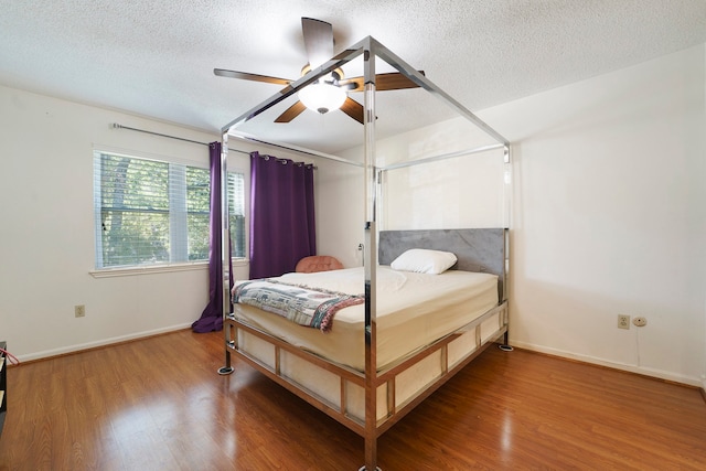 bedroom featuring ceiling fan, a textured ceiling, and hardwood / wood-style flooring