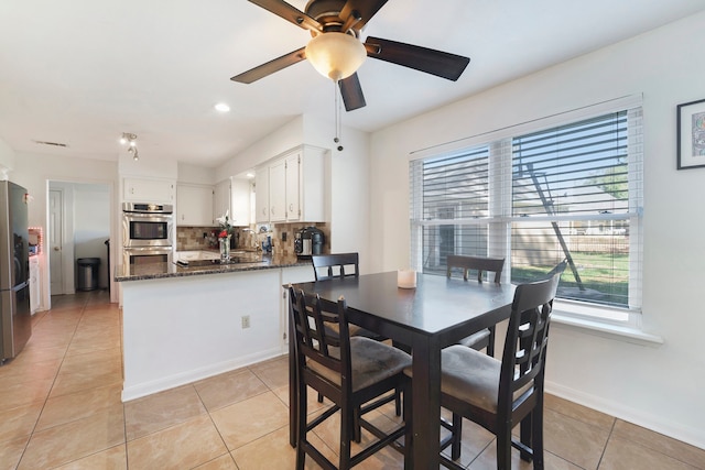 tiled dining room with ceiling fan