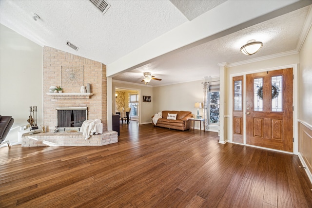 foyer featuring dark hardwood / wood-style floors, ceiling fan, a textured ceiling, and a wealth of natural light