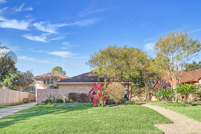 ranch-style home with a front yard