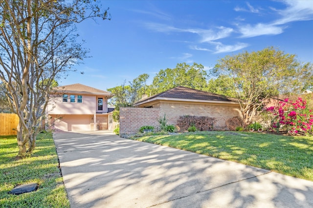 view of front of home with a front yard and a garage