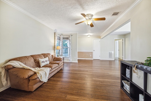 living room featuring hardwood / wood-style floors, ceiling fan, crown molding, and a textured ceiling