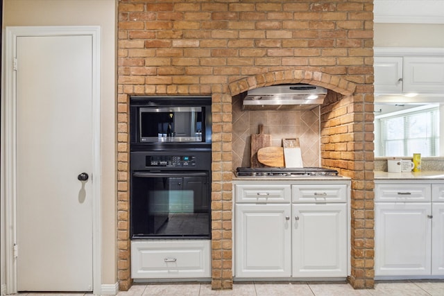 kitchen with light tile patterned flooring, white cabinetry, and appliances with stainless steel finishes