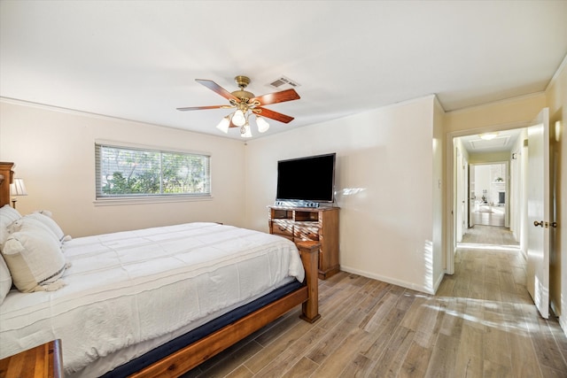 bedroom with light hardwood / wood-style flooring, ceiling fan, and ornamental molding