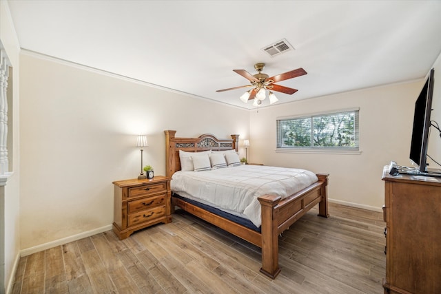 bedroom with ceiling fan, light hardwood / wood-style floors, and ornamental molding