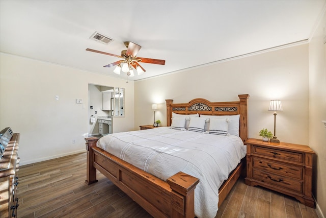 bedroom featuring ceiling fan, crown molding, and dark wood-type flooring