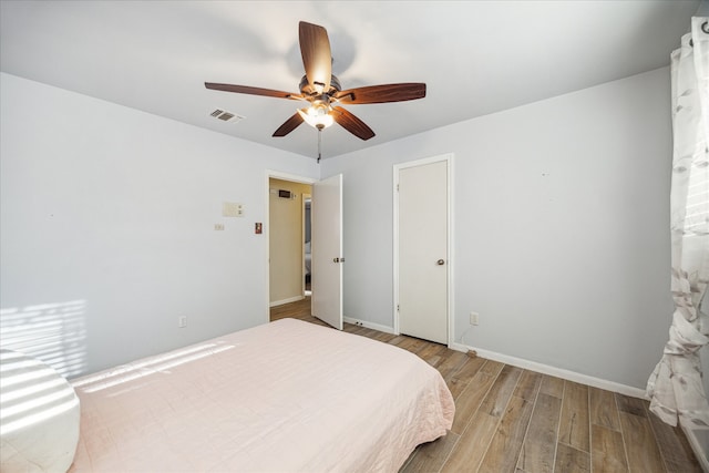 bedroom with light wood-type flooring and ceiling fan